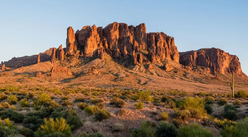 Wide golden-hour view of the Superstition Mountains along the Apache Trail